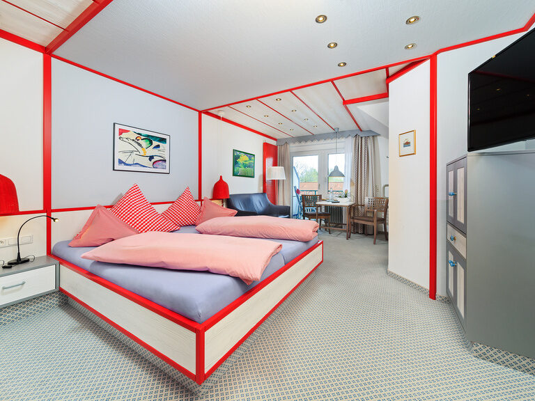 Im Doppelzimmer Deluxe kann vom Bett aus auf dem großen Flachbild-TV fernsehen