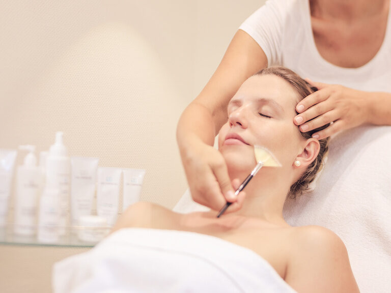 Eine Frau erhält eine Gesichtsbehandlung im Spa-Breich im Hotel Edelweiss im Allgäu.